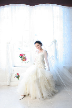 Asian beautiful bride in wedding dress with flowerの写真素材
