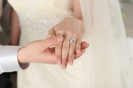 Focus on wedding ring on bride fingersの写真素材