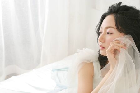Portrait of Asian beautiful bride expressionless faceの写真素材