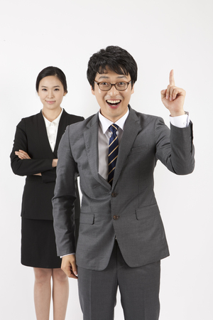 Asian business man and woman pointing gesture isolated on whiteの写真素材