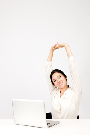 Asian business woman using laptop isolated on whiteの写真素材