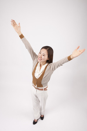 From above Asian beautiful woman giving cheers isolated on whiteの写真素材