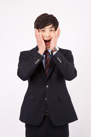 Asian business man with surprised isolated on whiteの写真素材