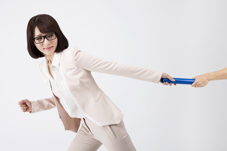 Portrait of Asian business woman passing the baton isolated on whiteの写真素材