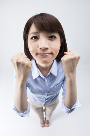 Portrait of from above Asian female teacher in cheer up gesture isolated on whiteの写真素材