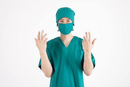 Portrait of Asian male surgeon with clean hand begore surgery isolated on whiteの写真素材