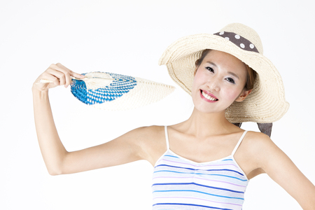 Asian woman in sunglasses holding fan on summer day isolated on whiteの写真素材