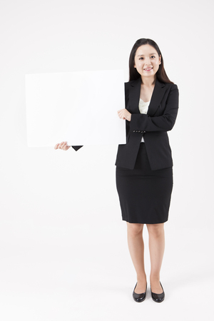 Asian beautiful woman with white board isolated on whiteの写真素材
