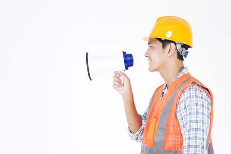Asian male Engineers holding loudspeaker isolated on whiteの写真素材