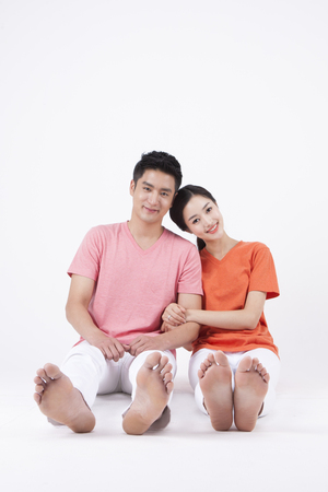 Asian happy couple enjoying day isolated on whiteの写真素材