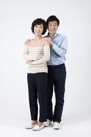 Asian middle aged couple having good time isolated on whiteの写真素材