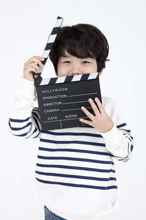 Asian boy director with clapper isolated on whiteの写真素材