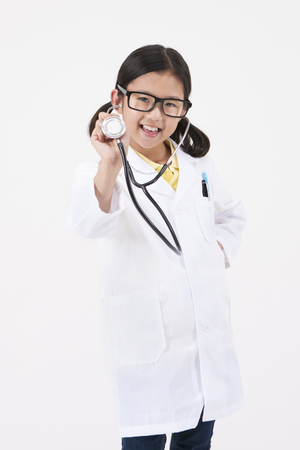 Asian female child doctor with stethoscope isolated on whiteの写真素材