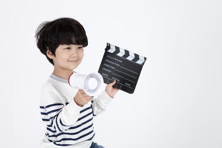 Asian boy director with clapper isolated on whiteの写真素材