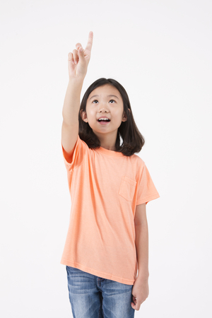 Asian female child pointing gesture isolated on whiteの写真素材