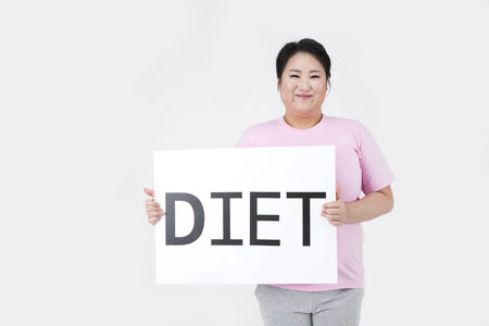 Asian overweight woman decides to go on a diet isolated on whiteの写真素材