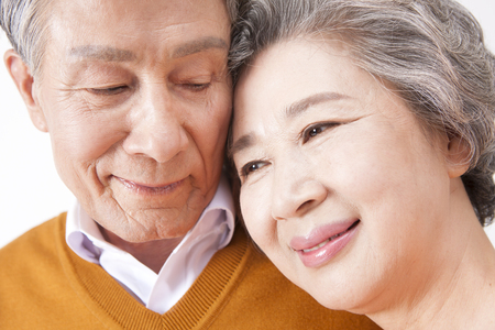 Asian old aged couple having good time isolated on whiteの写真素材