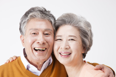 Asian old aged couple with smile isolated on whiteの写真素材