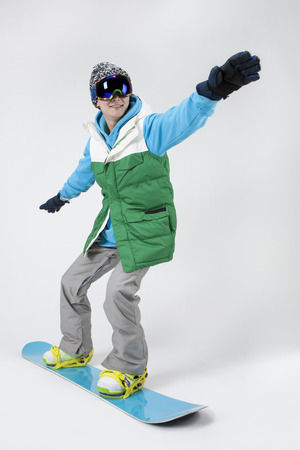 Asian young man enjoying snowboarding isolated on whiteのeditorial素材