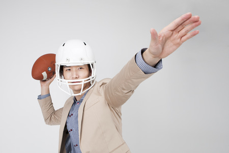 Asian business man playing rugby isolated on whiteのeditorial素材