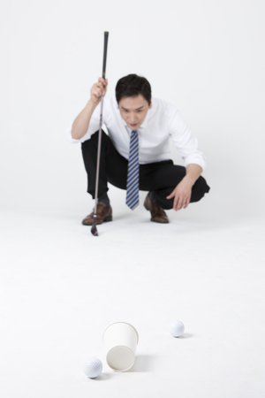 Asian business man playing golf isolated on whiteのeditorial素材