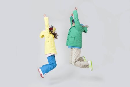 Asian young couple jumping and enjoying winter vacation isolated on whiteのeditorial素材