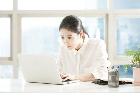 Asian business woman working with desktop in officeの写真素材
