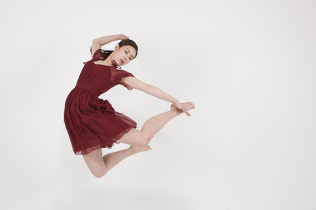 Asian young woman doing ballet with isolated on whiteの写真素材