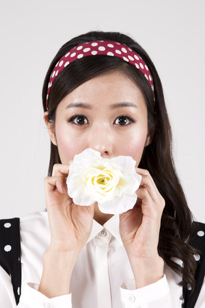 Asian retro woman with flower isolated on whiteの写真素材