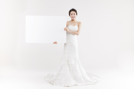 Asian beautiful bride with white panel isolated on whiteの写真素材