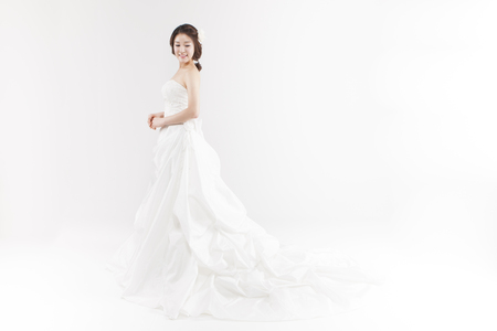 Asian beautiful bride with bouquet isolated on whiteの写真素材