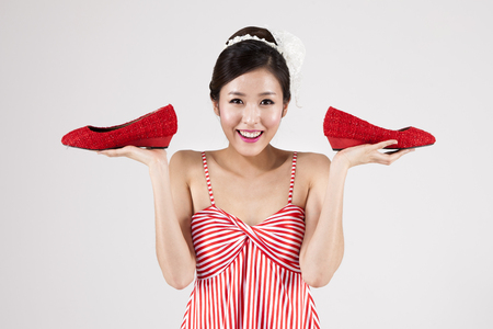 Asian retro woman with red shoes isolated on whiteの写真素材