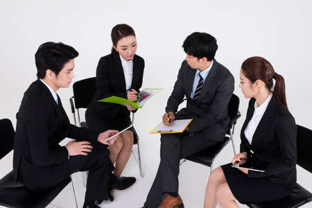 Group of Asian business people discussing isolated on whiteの写真素材
