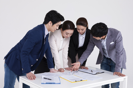 Group of Asian business people discussing isolated on whiteの写真素材