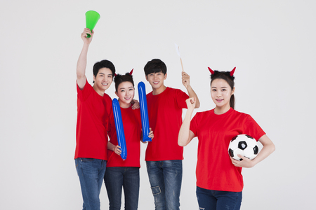 Group of Asian young people are cheer for soccer team isolated on whiteの写真素材