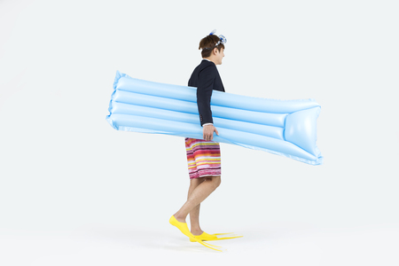 Asian man in half suit and shorts enjoying summer vacation isolated on whiteの写真素材