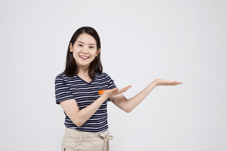 Asian female part time worker putting her palms up isolated on whiteの写真素材