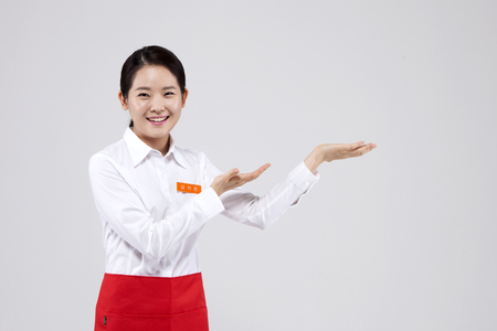 Asian female part time worker putting her palms up isolated on whiteの写真素材