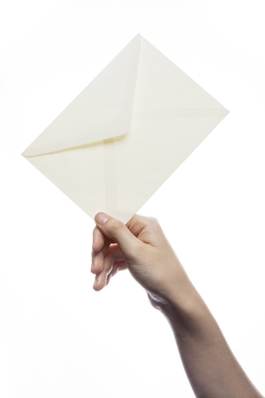 Hand holding blank envelope isolated on whiteの写真素材