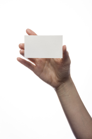 Hand holding blank business card isolated on whiteの写真素材