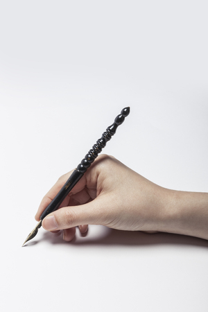 Hand writing with Fountain pen isolated on whiteの写真素材
