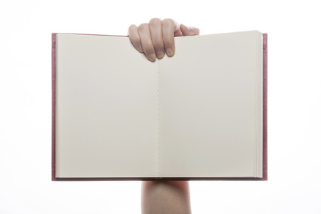 Hand holding open notebook isolated on whiteの写真素材