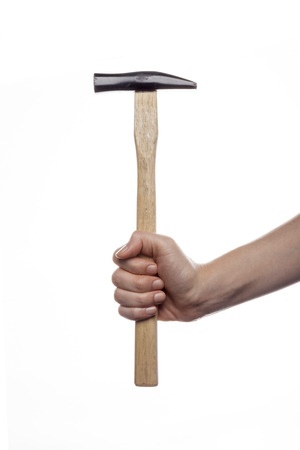 Hand holding hammer isolated on whiteの写真素材