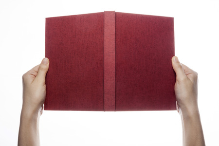 Hand holding open notebook isolated on whiteの写真素材