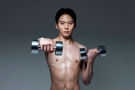 Asian fitness man doing exercise isolated on whiteの写真素材