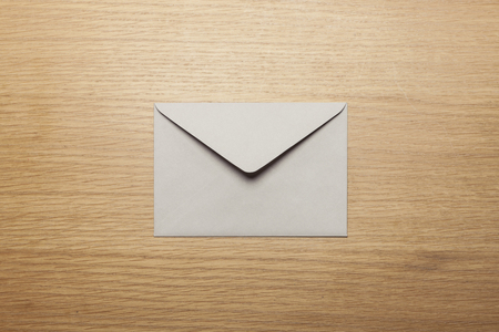 Grey envelope on wooden tableの写真素材