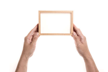 Hand holding wooden picture frame isolated on whiteの写真素材