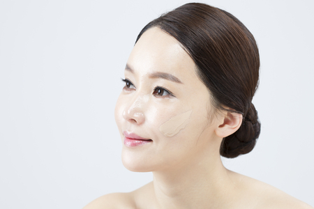 Asian beautiful woman with smile isolated on whiteの写真素材