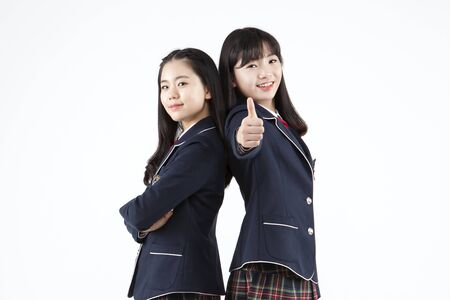 Asian female high school students with smile isolated on whiteの写真素材