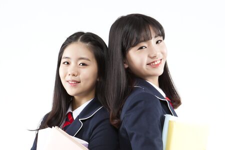 Asian female high school students with smile isolated on whiteの写真素材